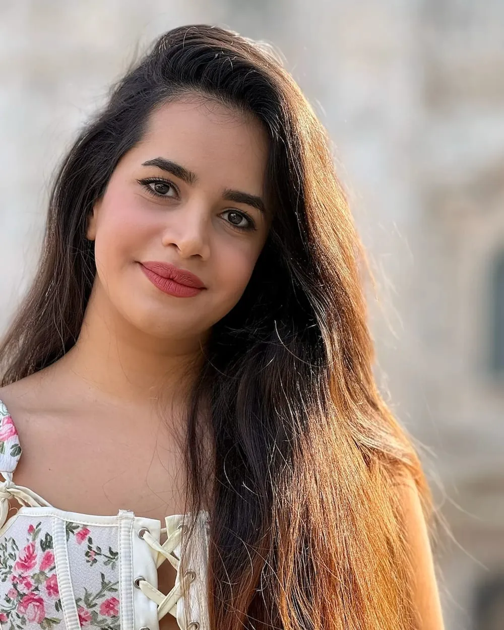 Neda in a floral top, in warm evening light